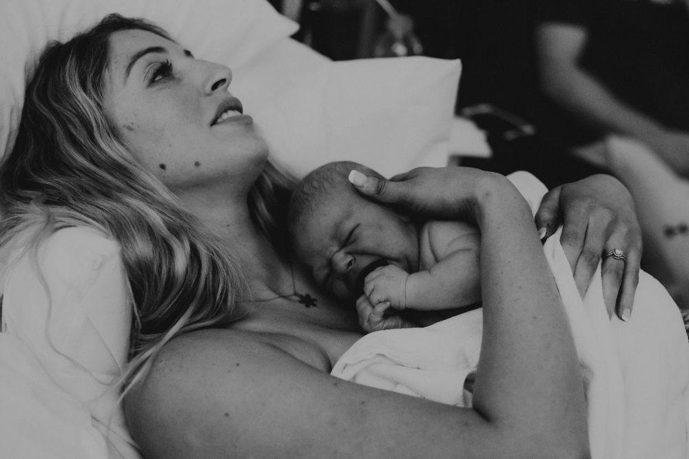 holding new born baby after childbirth