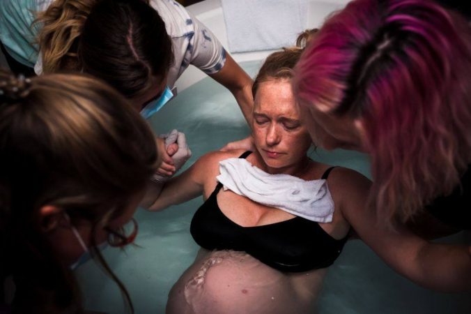 natural water birth under water with a nurse midwife in our birthing tubs
