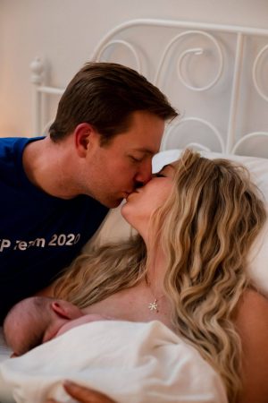 couple kissing after childbirth